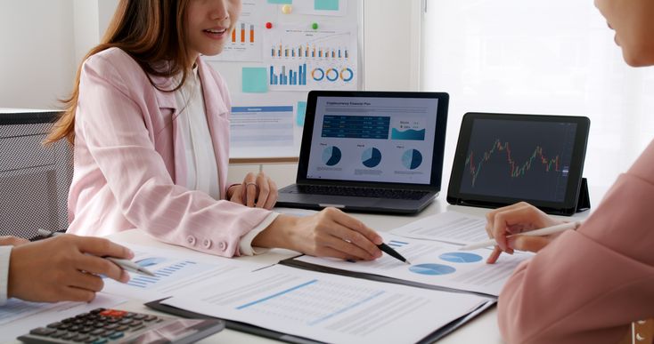 Laptop showing financial dashboard with charts